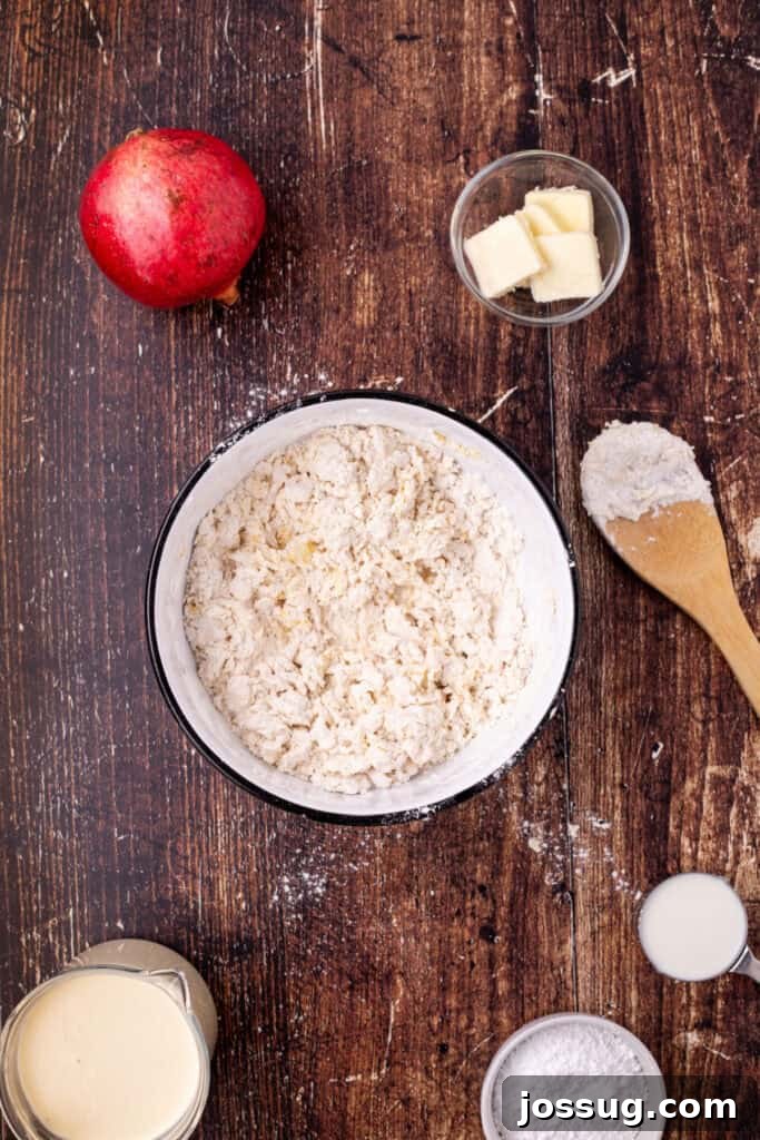 Mixing bowl showing flour and eggs partially mixed into a rough dough with a wooden spoon and ingredients nearby, illustrating the early stages of batter preparation.