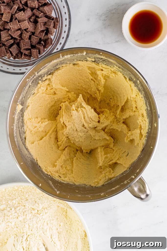 Light and fluffy creamed butter and sugars in a mixing bowl, showing the perfect texture before adding eggs.