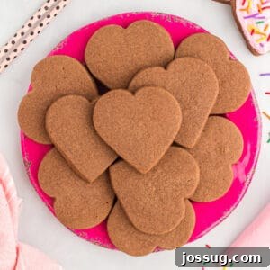 Heart-shaped chocolate cookies on a pink plate.