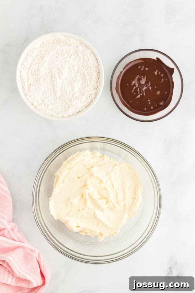 Creamed butter and sugar next to flour mixture and melted chocolate.