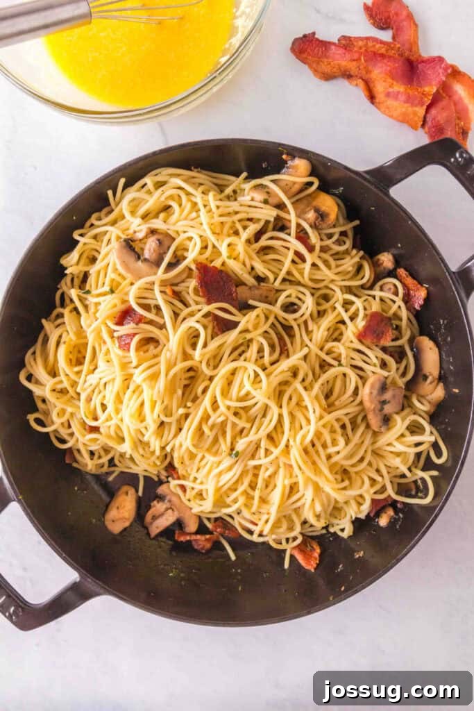 Bacon & Mushroom Carbonara 8 Adding spaghetti to the skillet