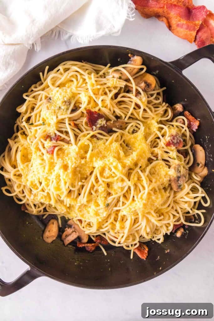 Bacon & Mushroom Carbonara 9 Pouring egg mixture over pasta