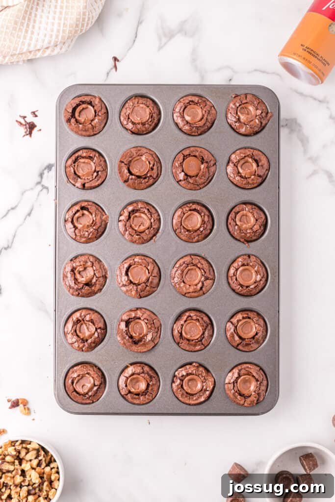 Warm brownie bites in the pan with a Rolo candy pressed into the center of each one.