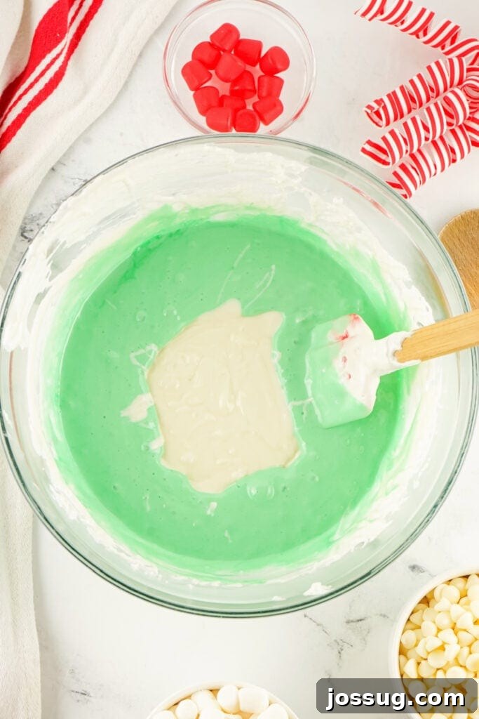 Grinchmas Nougat Nibblers 7 Mixing chocolate into marshmallows.