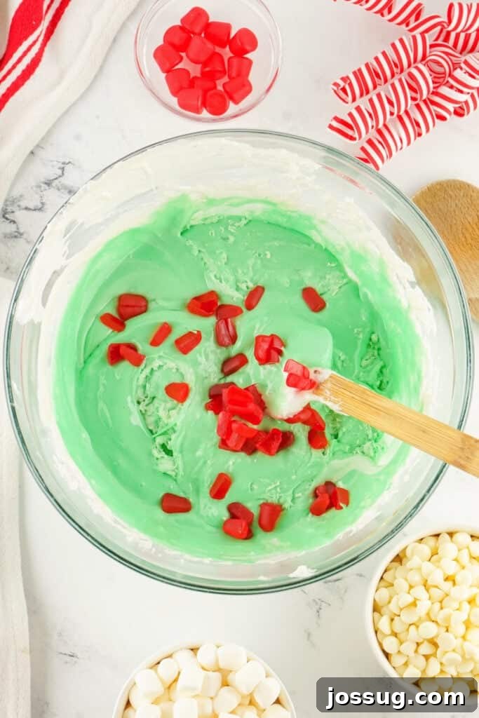 Grinchmas Nougat Nibblers 8 Adding gumdrops to nougat.
