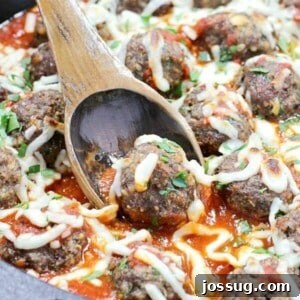 A plate of perfectly golden-brown Italian Herb Baked Meatballs, garnished with fresh parsley.
