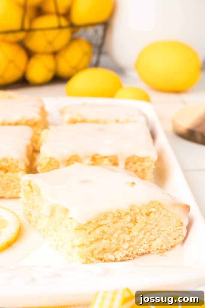 Lemon brownies arranged neatly on a white serving platter, ready to be enjoyed