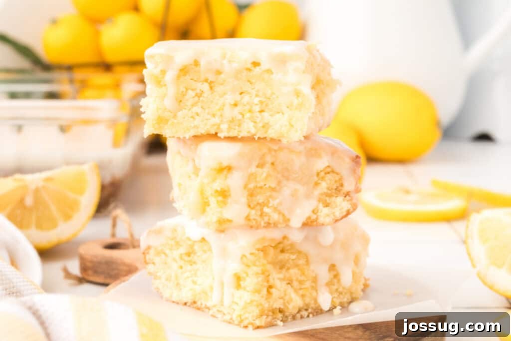 Stacked lemon brownies, showcasing the moist interior and shiny glaze, ready for serving