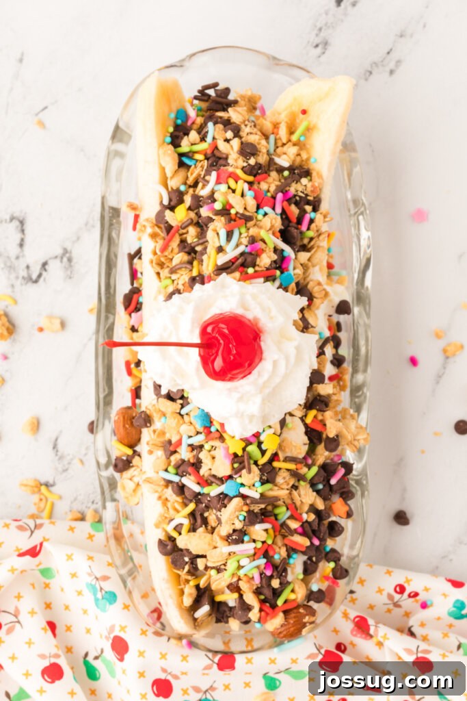 An appetizing breakfast banana split served in a classic banana boat dish, artfully arranged and ready to be enjoyed.