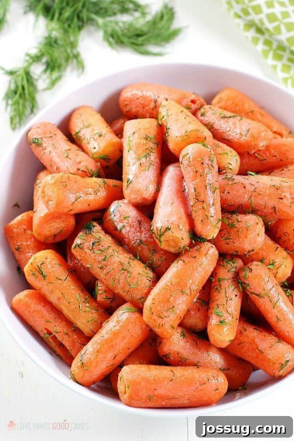 Vibrant Dill Butter Carrots served in a pristine white bowl, showcasing their tender texture and a sprinkle of fresh green dill.