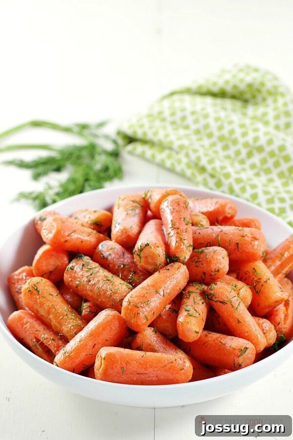A full bowl of golden Dill Butter Carrots, ready to be served, highlighting their vibrant color and fresh herb topping.