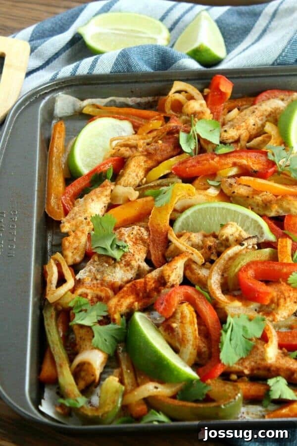 Sheet Pan Chicken Fajitas with fresh lime wedges, ready to serve.