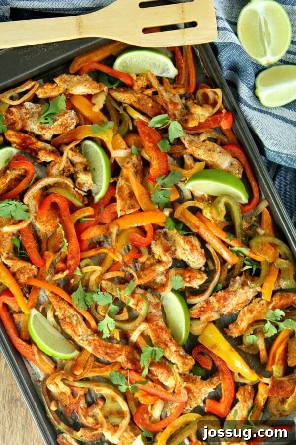 A vibrant platter of Sheet Pan Chicken Fajitas, ready to be served with limes.