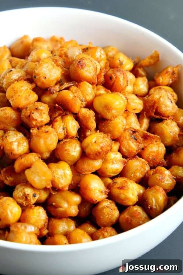 A white bowl generously filled with freshly prepared spicy roasted chickpeas, ready to be enjoyed.