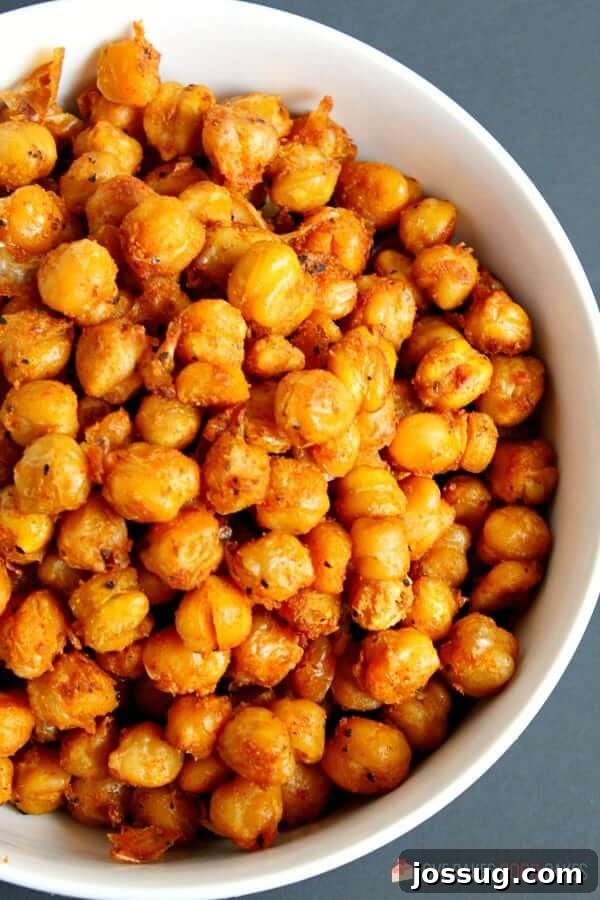 Another enticing view of spicy roasted chickpeas in a clean white bowl, highlighting their golden-brown color and appealing texture.