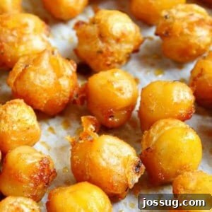 A close-up of a bowl of spicy roasted chickpeas, a healthy and high-protein snack.