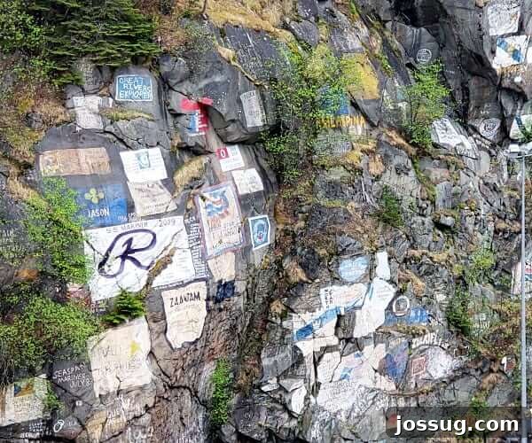 Last-Minute Cruises: Sail Sooner, Save More 3 A majestic rock face rises from the water in Skagway, Alaska, showcasing the raw beauty of the Alaskan wilderness.