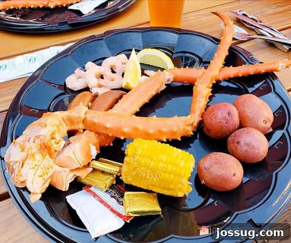 Smooth Sailing from the Start: Embarkation Day Essentials 11 Seafood Feast on a plate with crab legs, corn on the cob, russet potatoes and shrimp.
