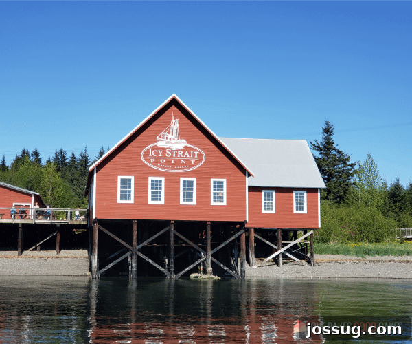Smooth Sailing from the Start: Embarkation Day Essentials 8 Icy Strait Point building sits on the shoreline with people standing on the deck area.