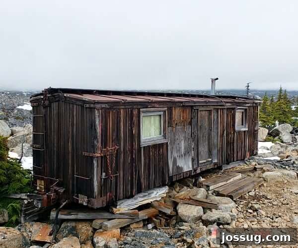 A wooden train car that has been converted to a living space.