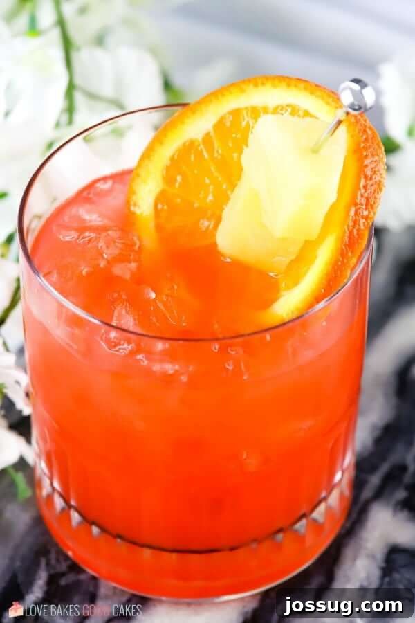 Golden Orange Pineapple Rum Delight 4 Another close-up of the Orange and Pineapple Rum Punch, garnished with fresh orange and pineapple.