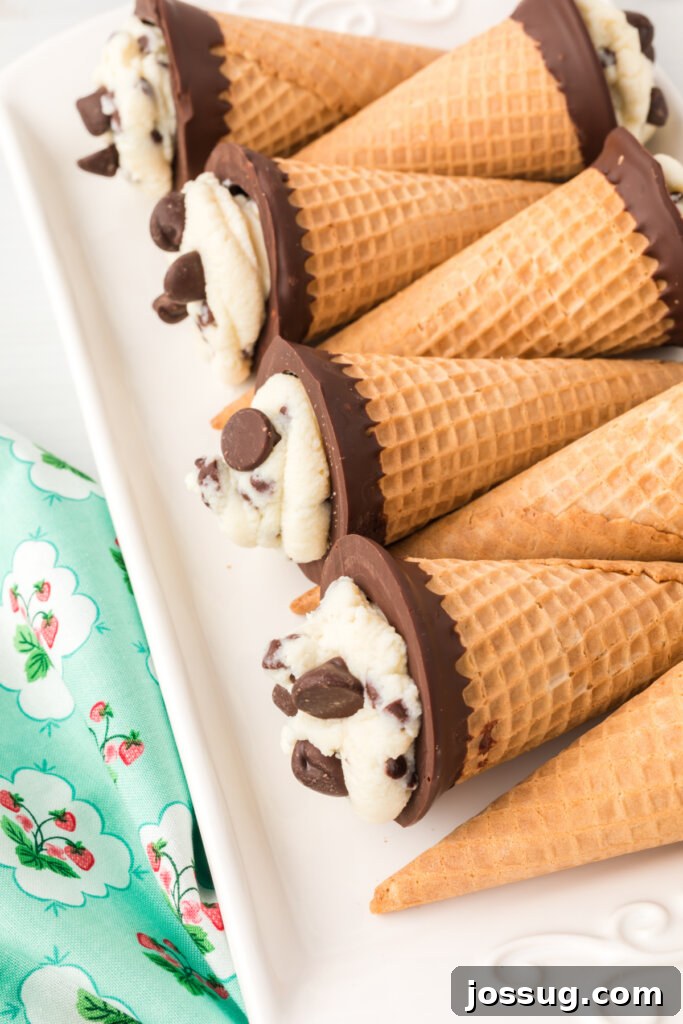 Cannoli Crunch Cones 3 A platter of freshly prepared Cannoli Cones, decorated with chocolate chips and ready for serving at a gathering.