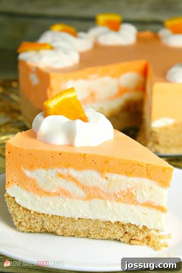 No-Bake Orange Creamsicle Cheesecake on a plate, ready to be served.