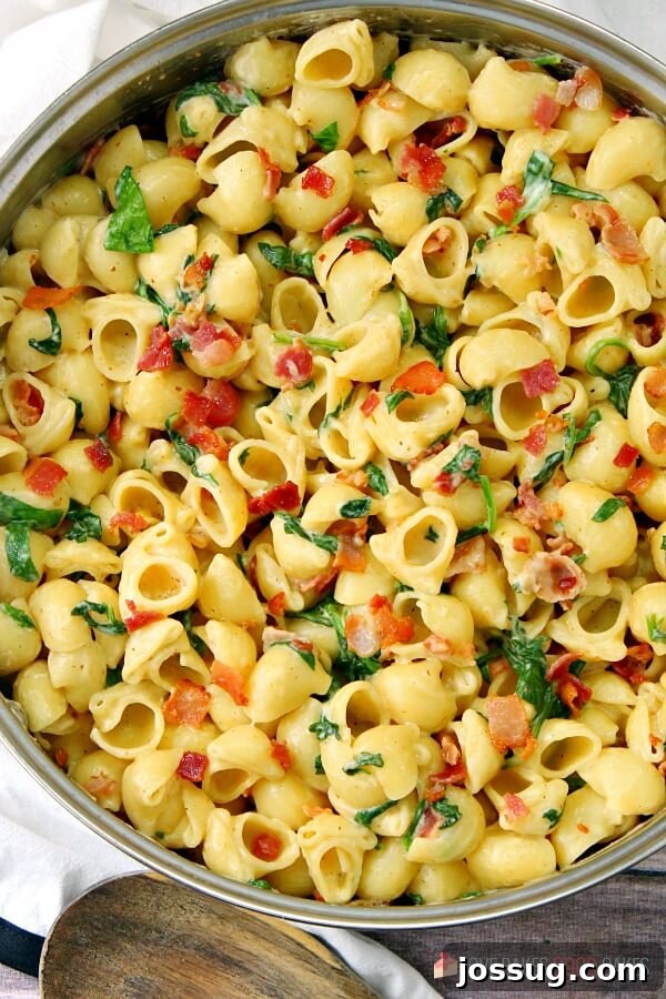 Effortless Creamy Bacon Spinach One-Pot Pasta 4 A wide shot of One-Pot Creamy Bacon Spinach Pasta simmering in a large skillet, steam rising, looking inviting.