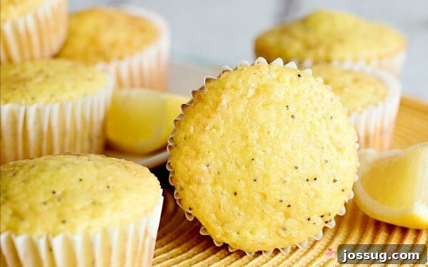 A beautifully arranged serving plate overflowing with golden Lemon Poppy Seed Muffins, ready to be enjoyed as a delightful treat.
