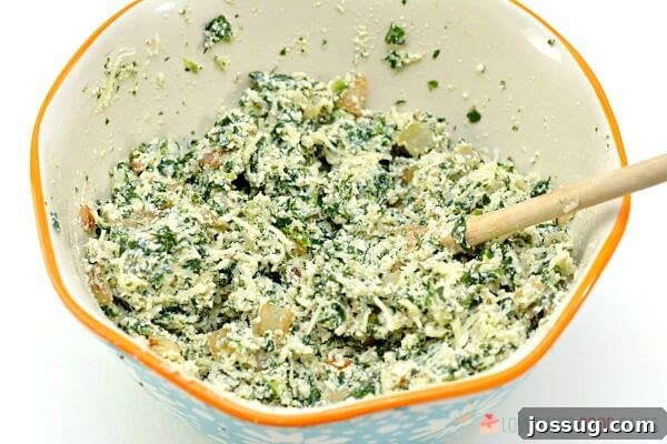 Spinach Ricotta Manicotti filling in a mixing bowl, ready for stuffing.
