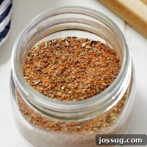 Homemade Cajun-Creole Seasoning in jar on white background