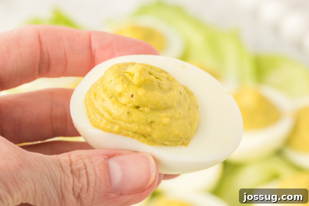 hand holding a finished deviled egg