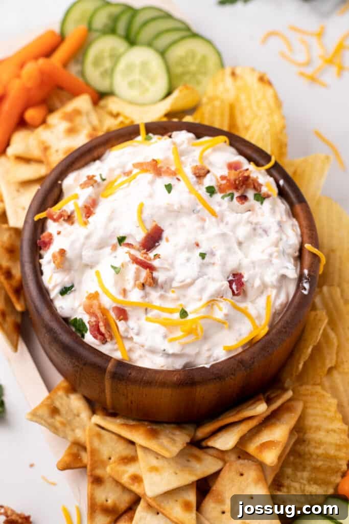 The Gourmet Gala Dip 4 A bowl of Million Dollar Dip, garnished with fresh parsley, ready for serving with dippers.