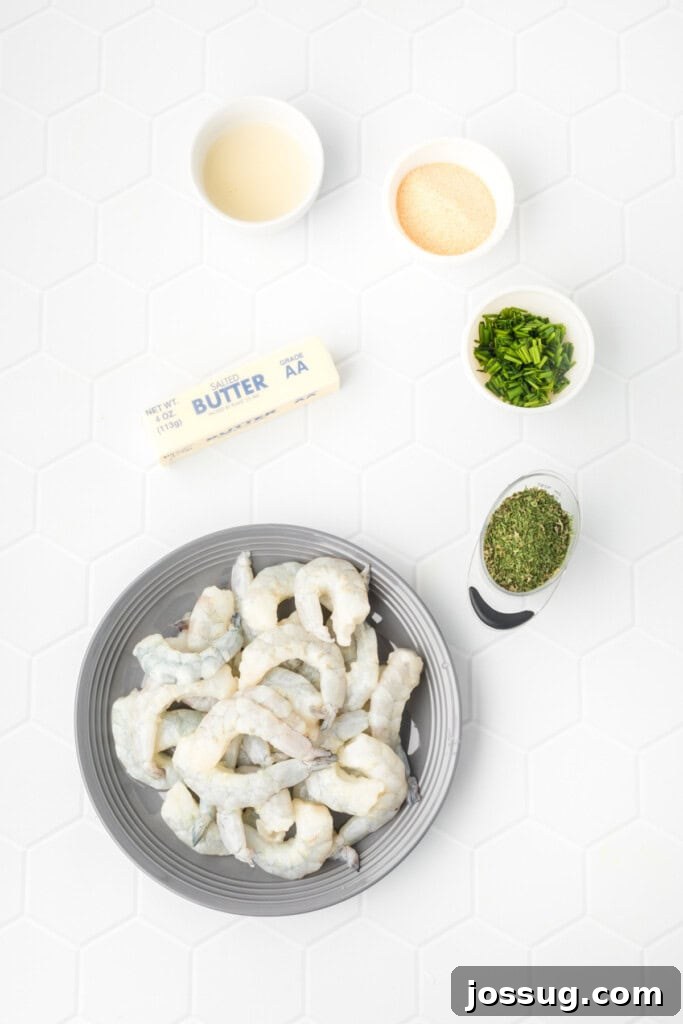Raw jumbo shrimp, softened butter, fresh lemon juice, granulated garlic, dried parsley, and chopped chives laid out on a clean surface.