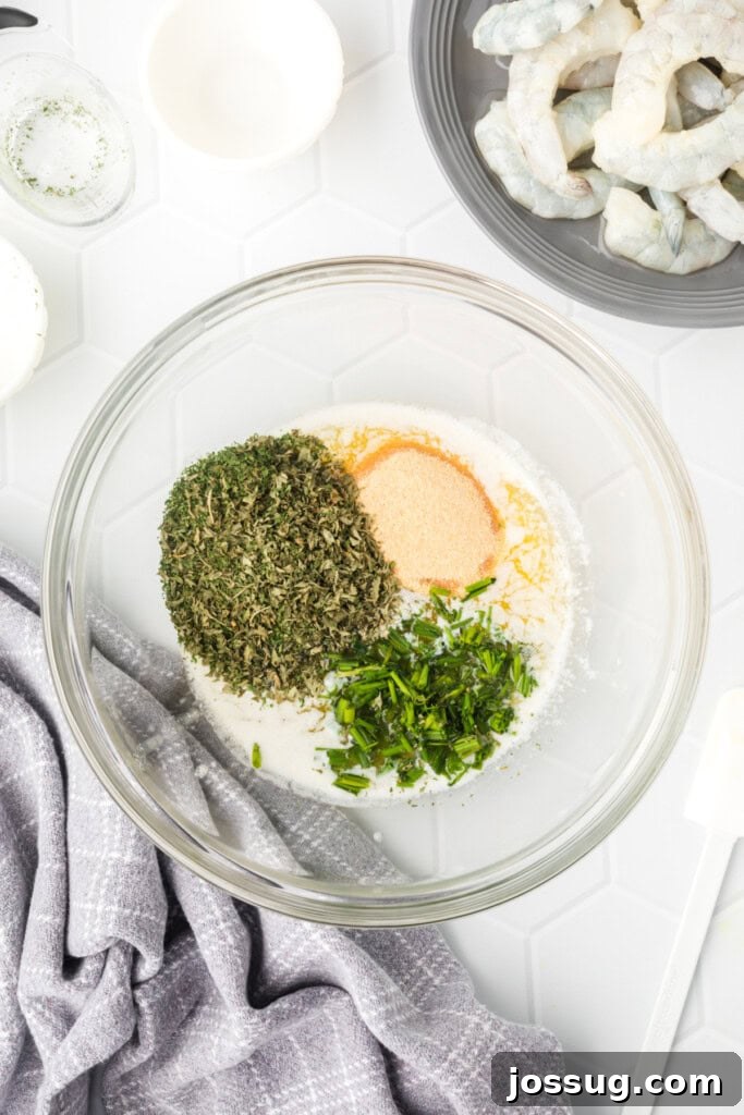 Dry seasonings and fresh chives being added to perfectly melted butter in a clear glass bowl, forming the base of the delicious marinade.