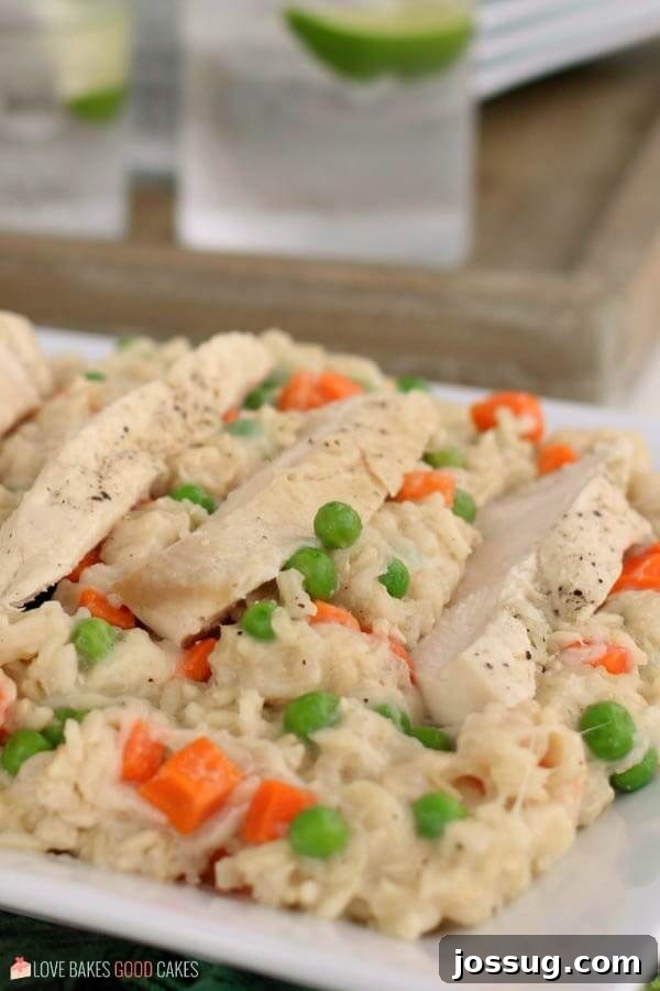 Slow Cooker Chicken and Rice is a cheesy chicken and rice casserole made in a slow cooker. Throw it together, set it, and forget it. Chicken and rice cooked in a slow cooker served on a platter up close.