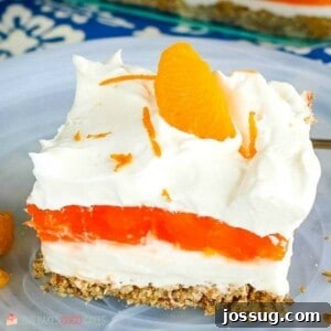 Orange Gelatin Pretzel Salad with distinct layers and whipped topping