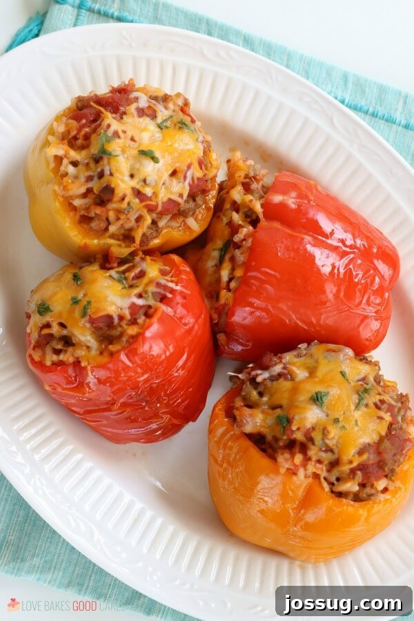 Best Ever Slow Cooker Stuffed Peppers Recipe with Ground Beef or Sausage Slow Cooker Stuffed Peppers on a white plate, ready to be served.