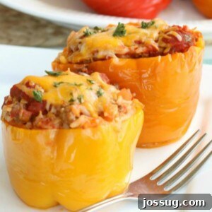 Slow Cooker Stuffed Peppers on a white plate with green garnish.