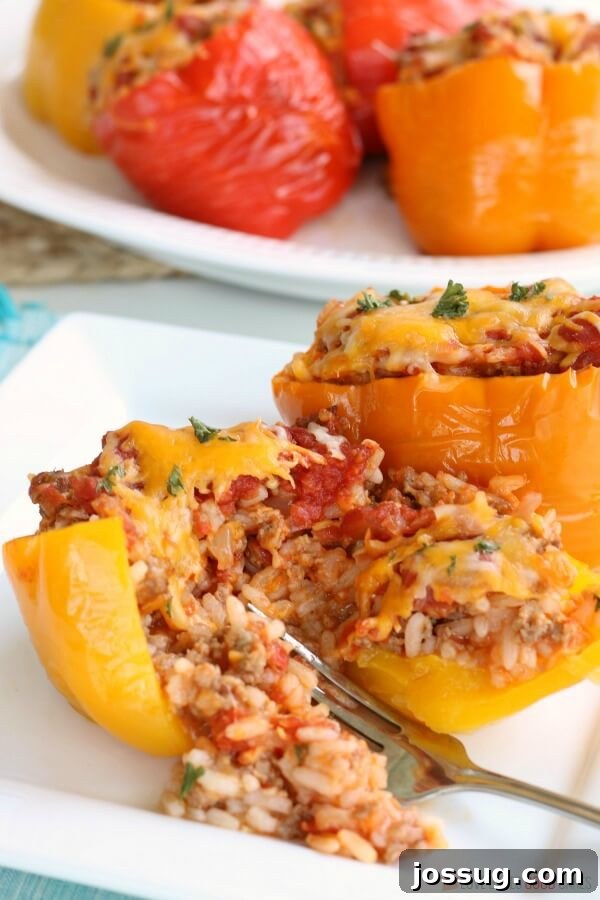 Enjoy Your Stuffed Peppers with Ease Slow Cooker Stuffed Peppers on a plate with a fork, showing the filling.