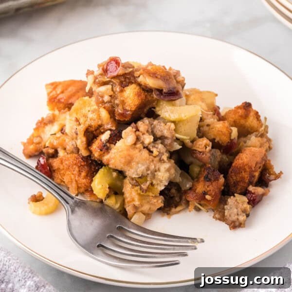 Cranberry Apple Sausage Stuffing on plate with fork