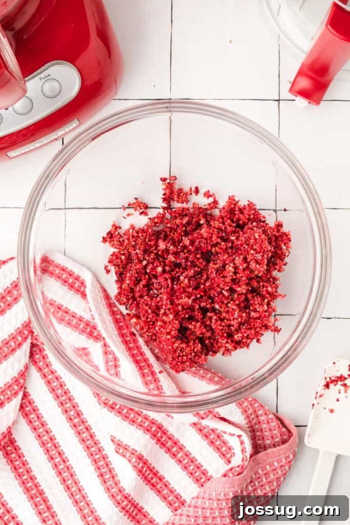 Cranberry Burst 6 Finely chopped orange pieces inside the red food processor, showing a bright yellow-orange mixture.