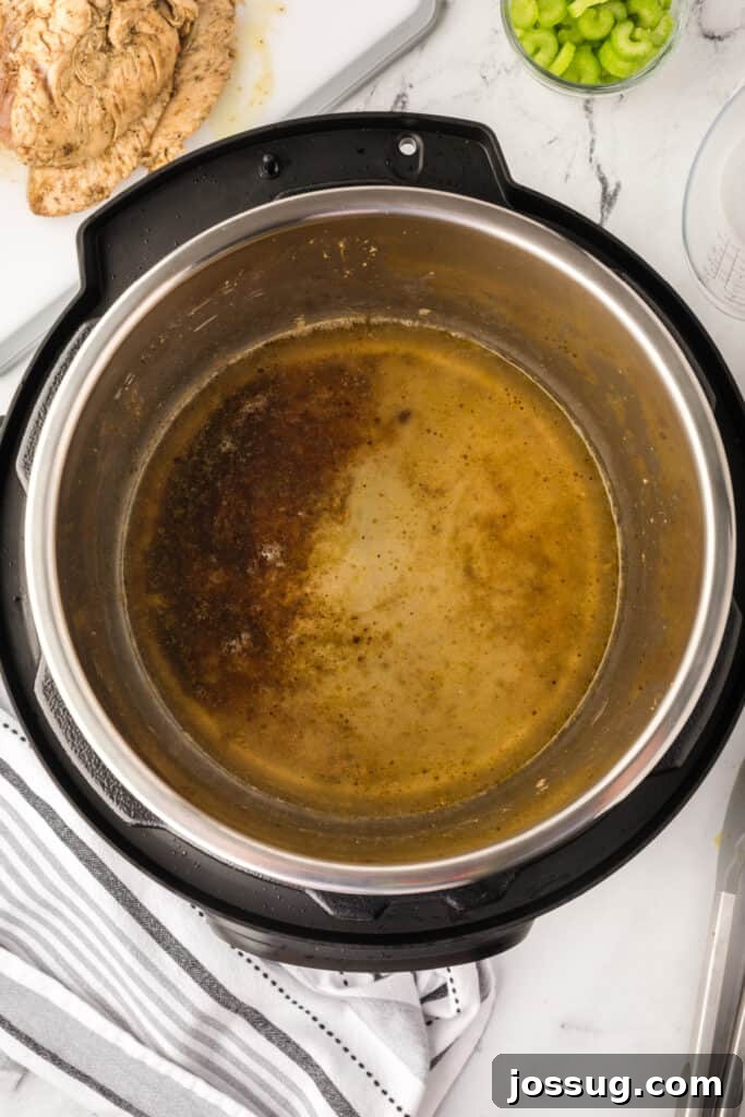 Inside view of Instant Pot showing brown cooking juices and drippings for making gravy.