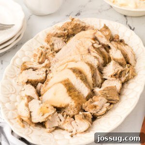 Square image of sliced Instant Pot turkey breast on a white platter with gravy on top, styled for social media or featured use.