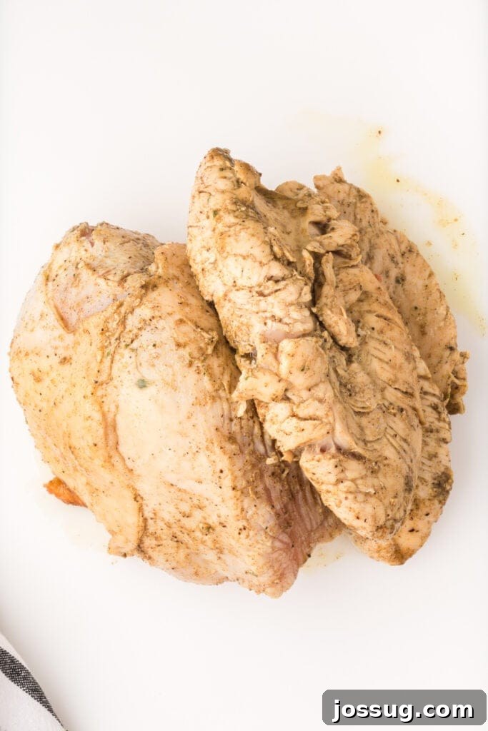 Cooked turkey breast resting on a white cutting board after pressure cooking.