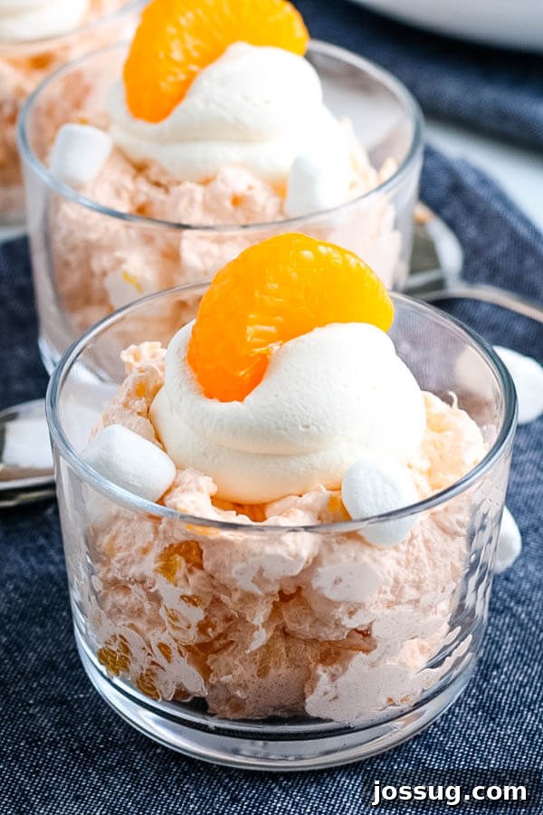 Creamsicle Dream Dessert 2 finished orange fluff salad in clear bowl, ready to serve