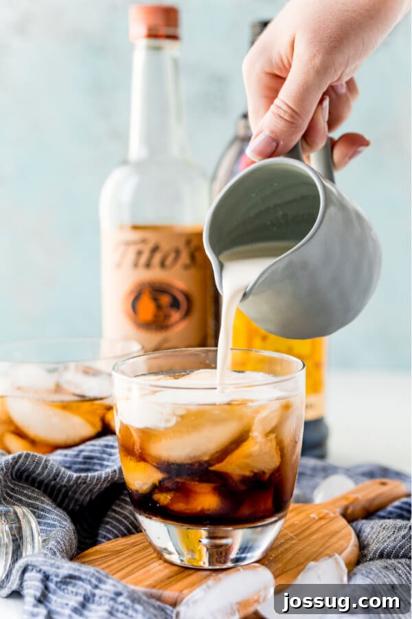 Velvet Russian 5 Cream being delicately poured into a White Russian cocktail
