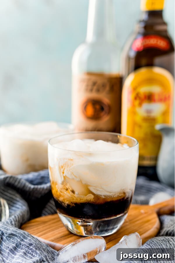 Velvet Russian 8 Multiple finished White Russian Cocktails with various alcohol bottles in the background