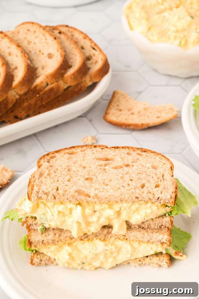 A classic old fashioned egg salad sandwich, cut in half to show the filling.