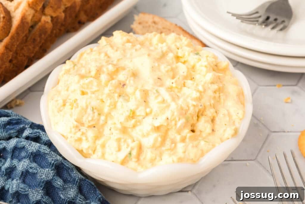 A large bowl filled with classic old fashioned egg salad, garnished lightly.